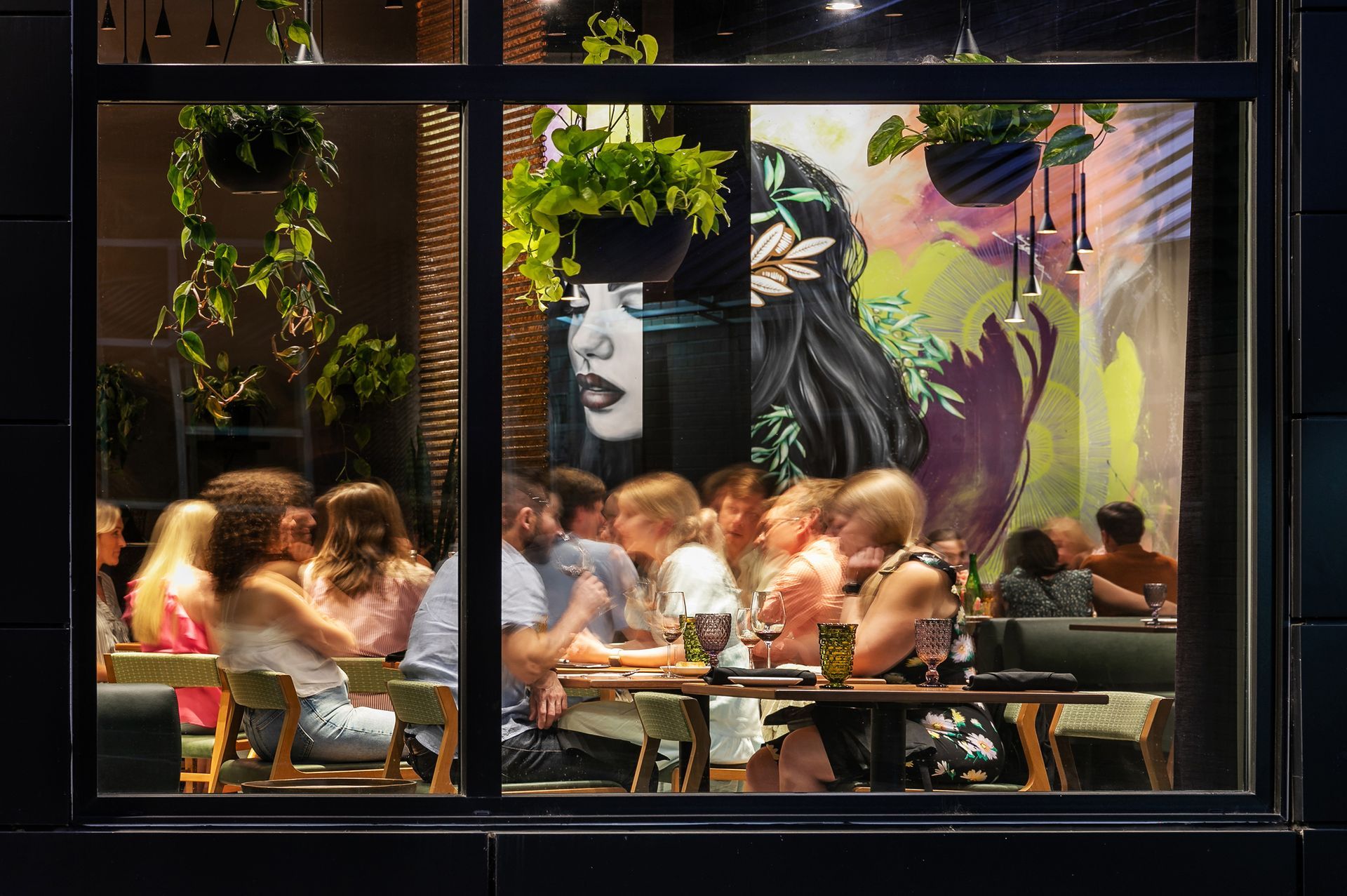 A group of people are sitting at tables in a restaurant.