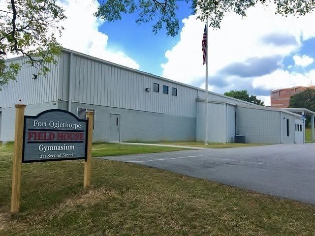 A large white building with a sign in front of it