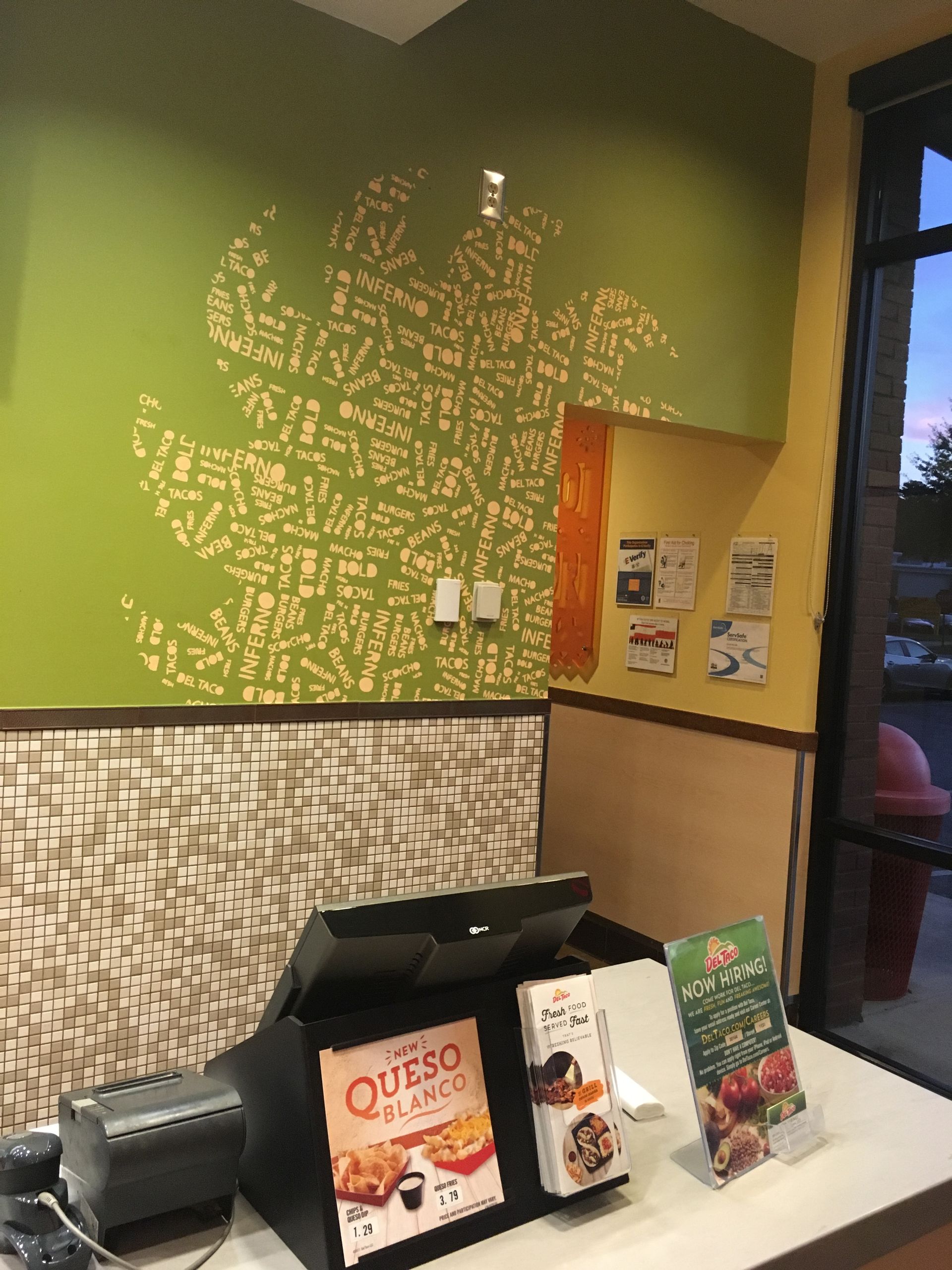 A counter in a restaurant that says queso on it