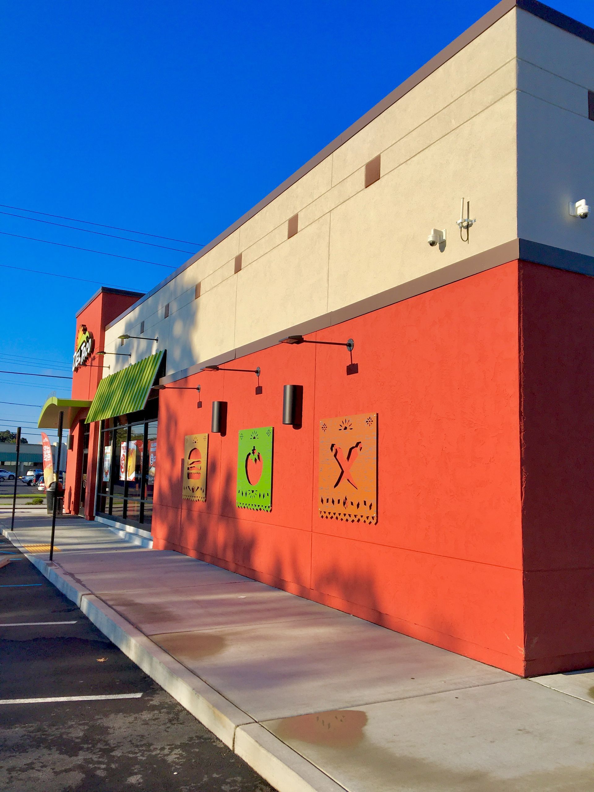 A red and white building with a green awning