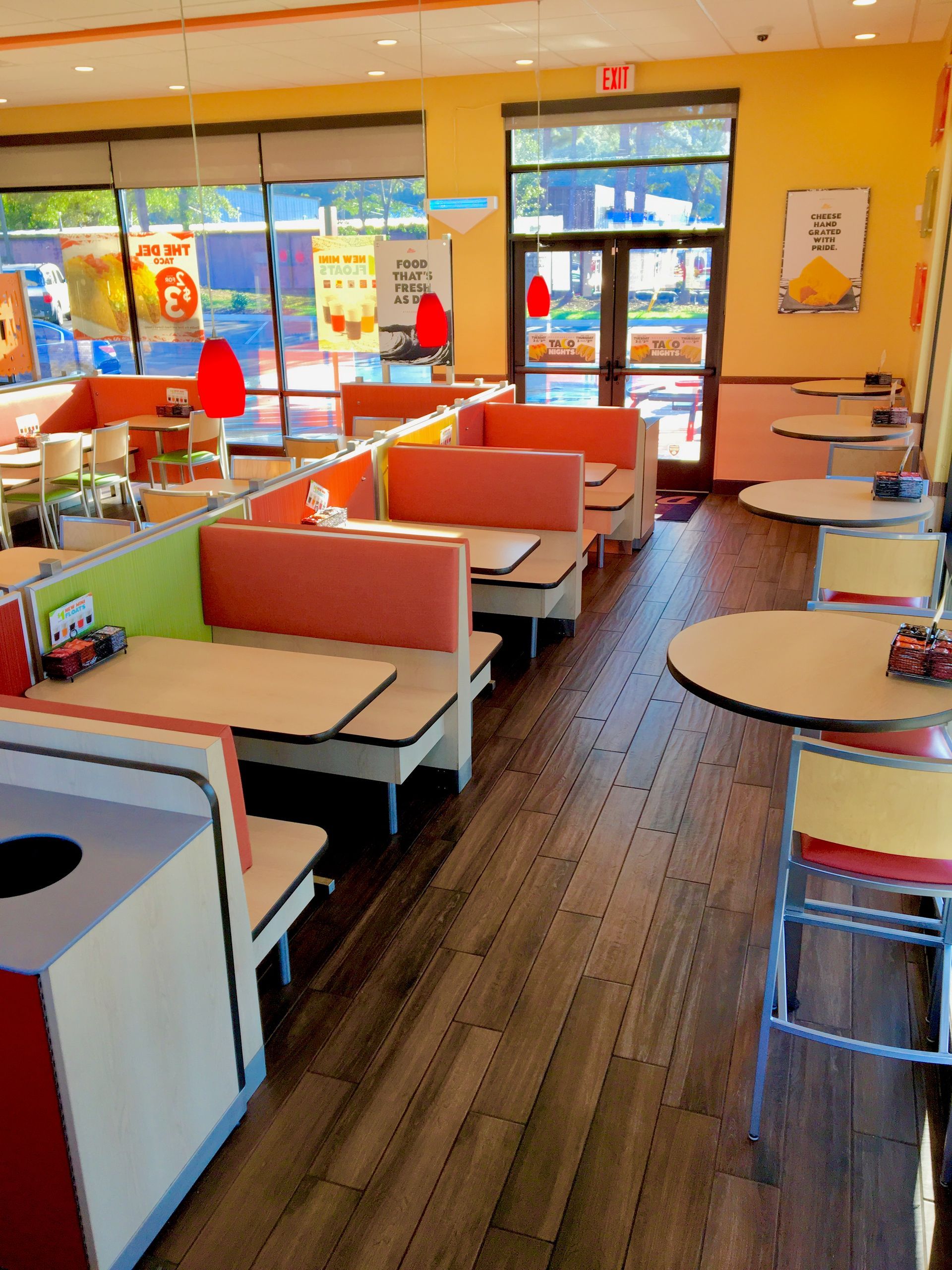 The inside of a fast food restaurant with tables and booths