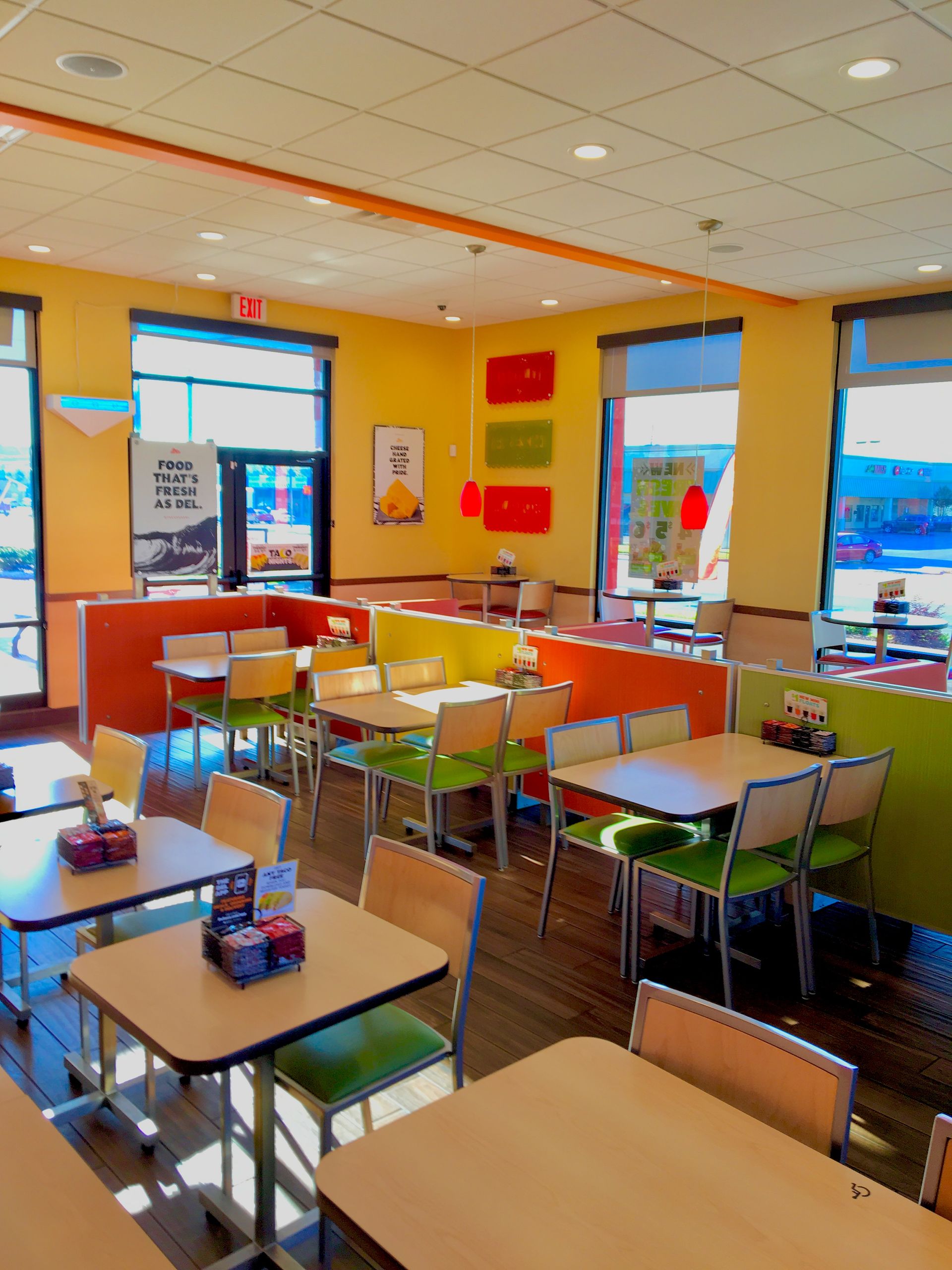 The inside of a restaurant with tables and chairs