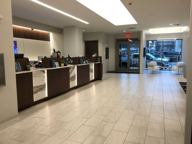 A bank lobby with a red exit sign