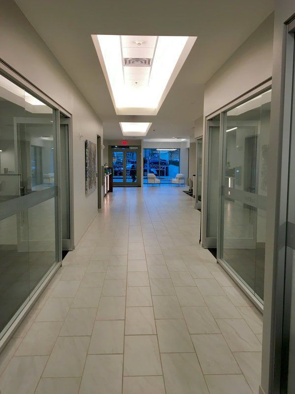 A long hallway with a lot of glass doors