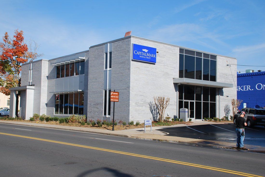 A white building with a blue sign that says ' kings ' on it