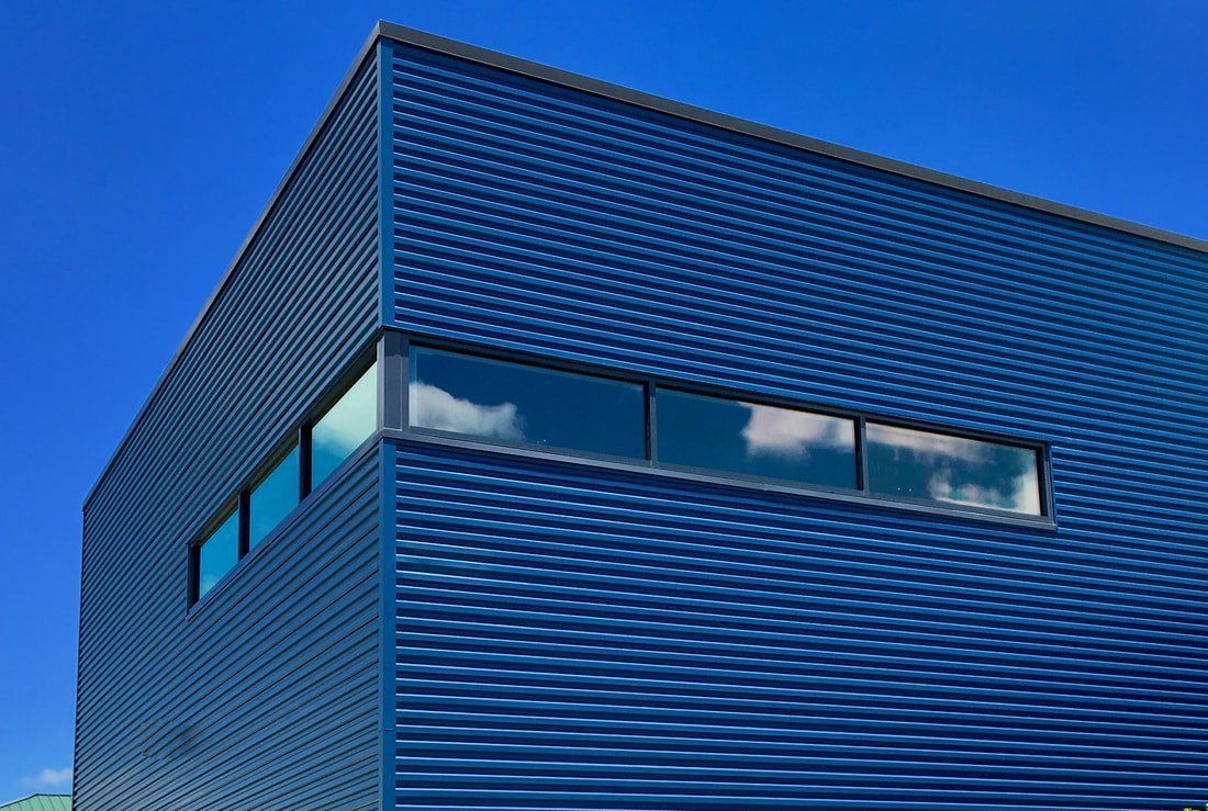A blue building with a blue sky in the background