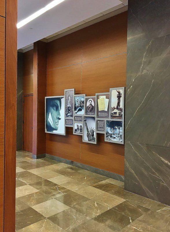 A hallway with a collage of pictures on the wall.