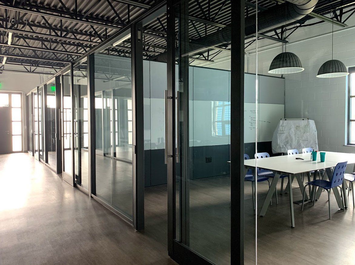 A conference room with a table and chairs in a building.