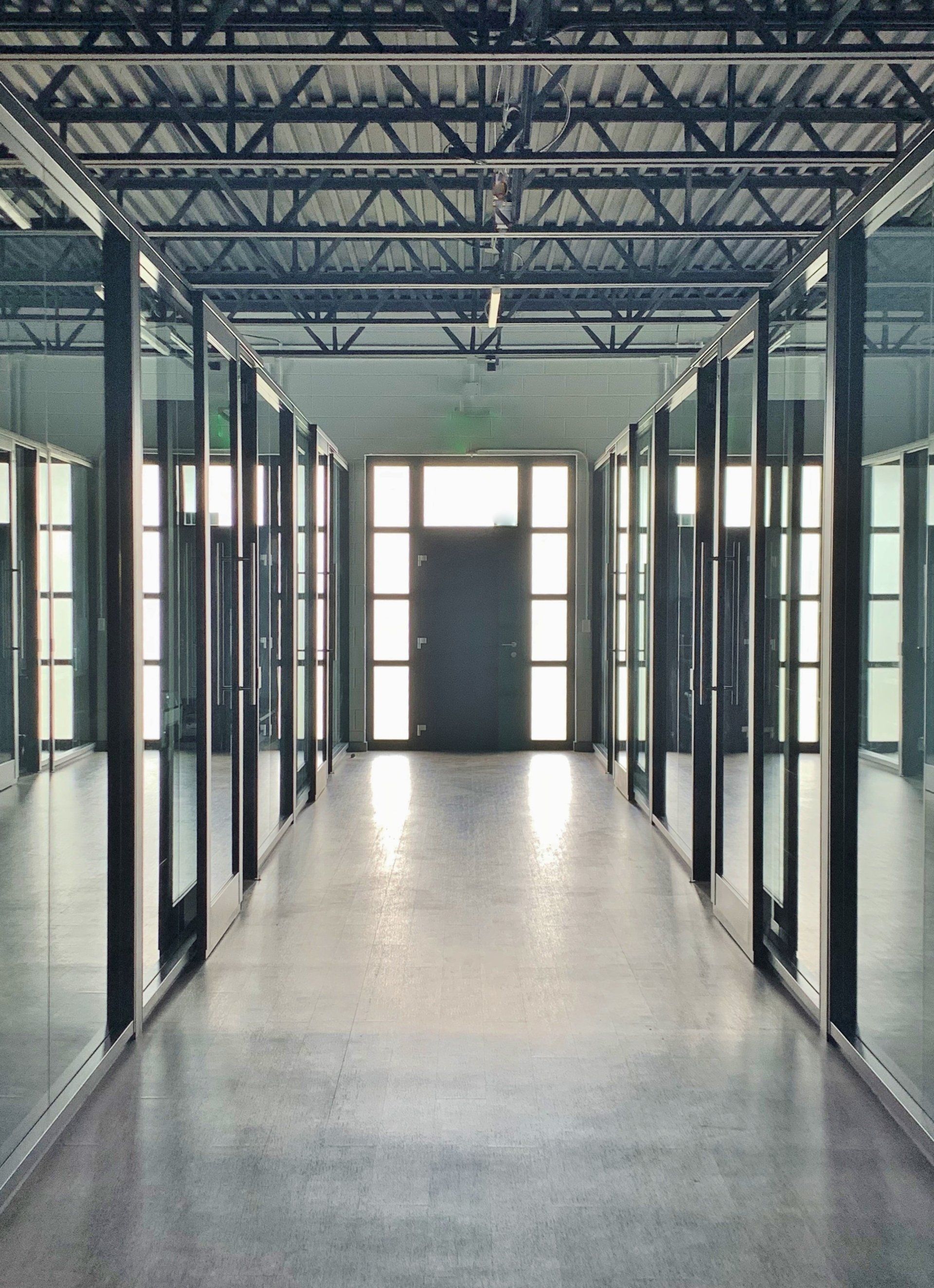 A long hallway with a door in the middle