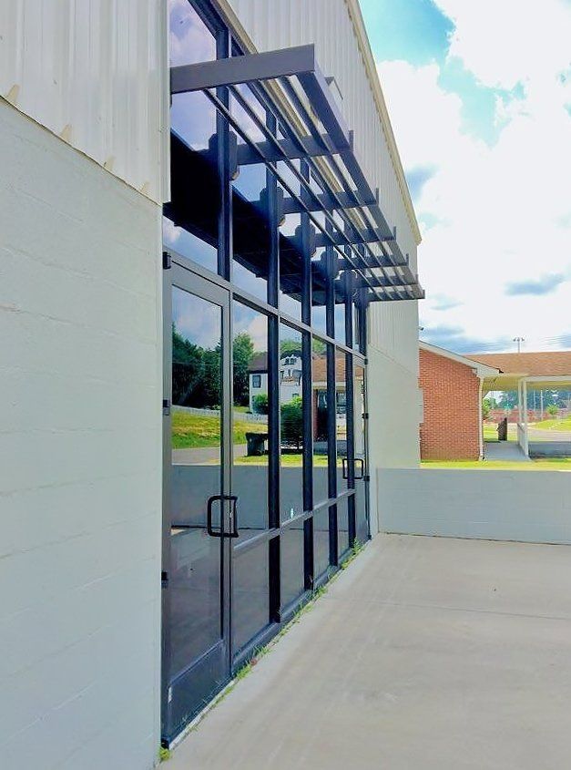 A building with a lot of windows and a canopy over the door.