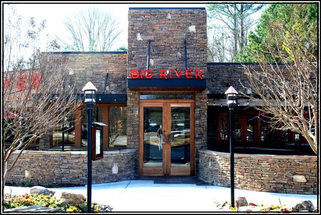 A large brick building with a sign that says big river