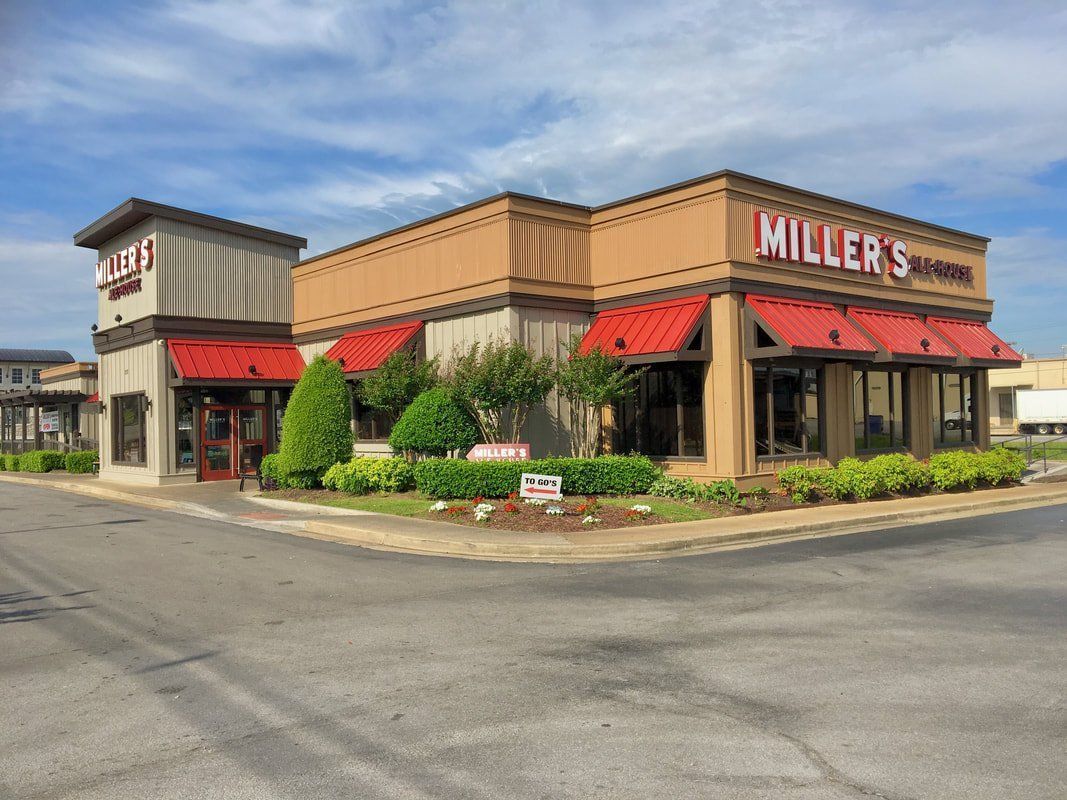 A miller 's restaurant is located on the corner of a street.