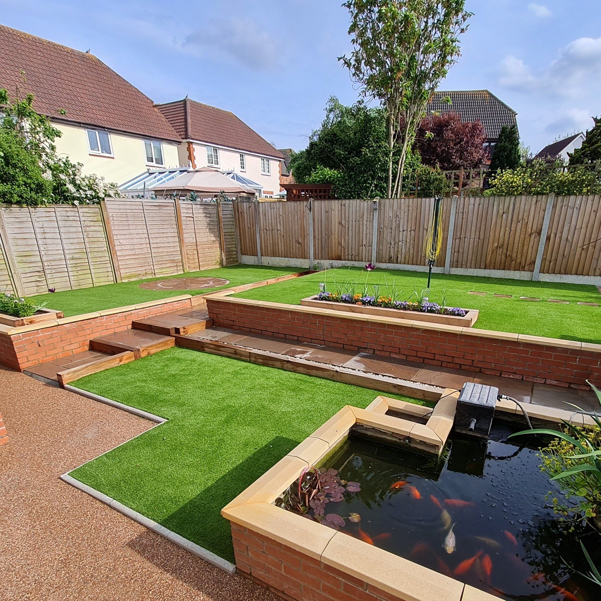 Artificial grass lawns on a landscaped Sudbury garden
