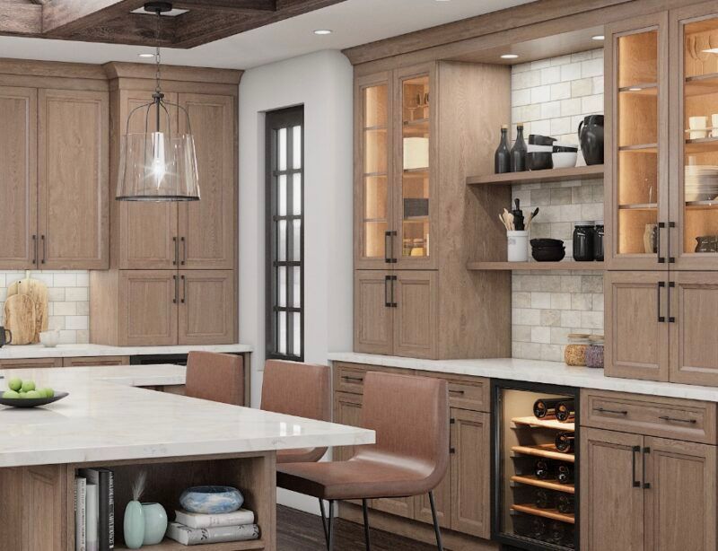 A modern kitchen with light wood cabinets, a white countertop, and a wine fridge.