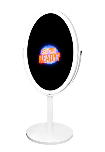 Oval tabletop mirror with black display reading “ARE YOU READY?” in orange and blue, on a white stand