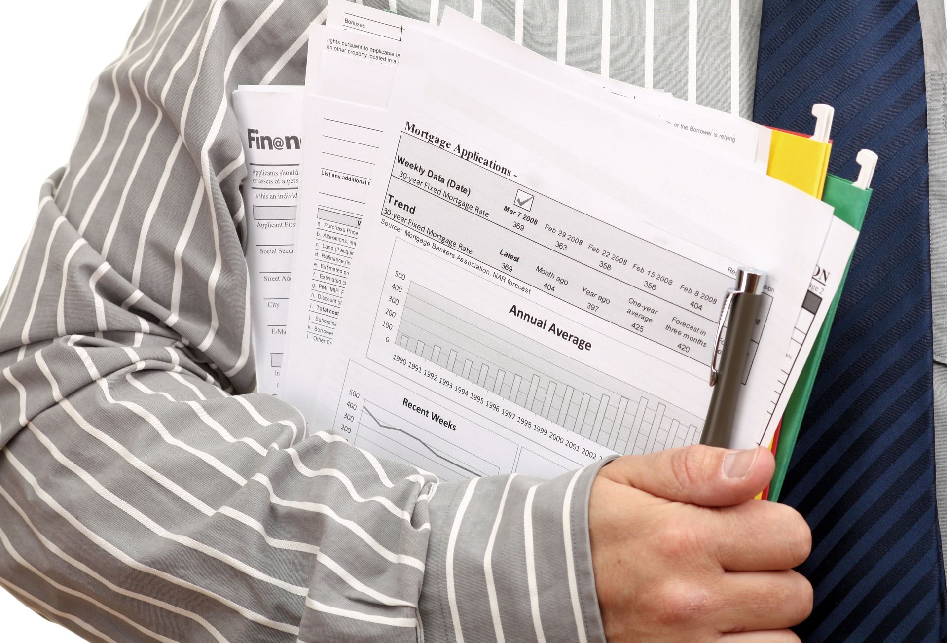 Person in striped shirt holding paperwork and a pen.
