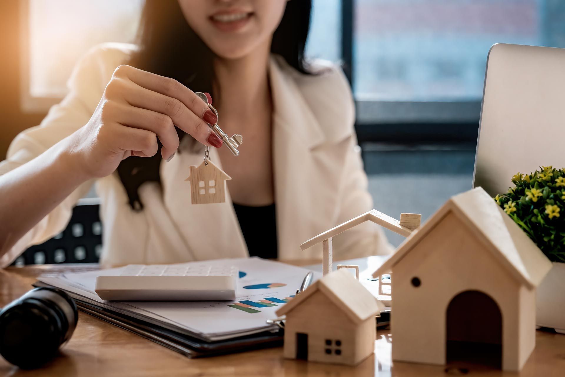 Real estate attorney handing over house keys at closing.