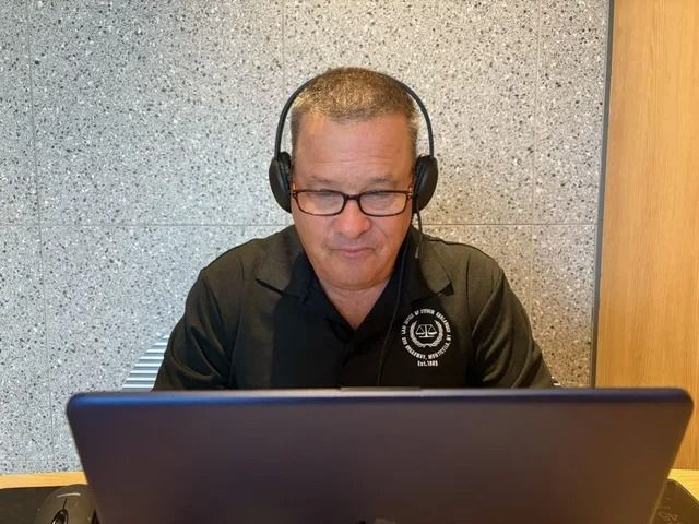 Steven Kurlander working at a laptop, available to discuss remote signing and closing arrangements.