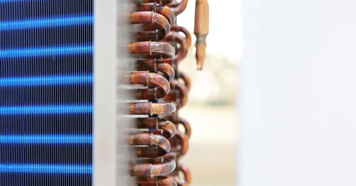 A large indoor heat exchanger with copper coils and aluminum, dual-tone blue fins in light and dark