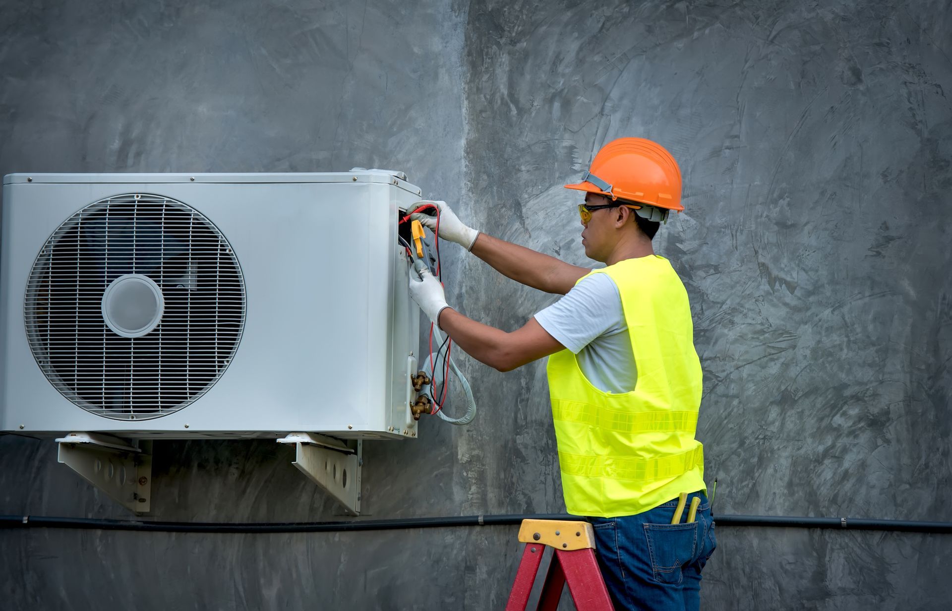 Technician is checking outdoor air conditioner unit.