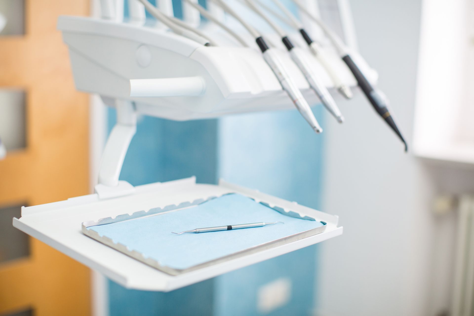 A dental chair with a clipboard and a pen on it.