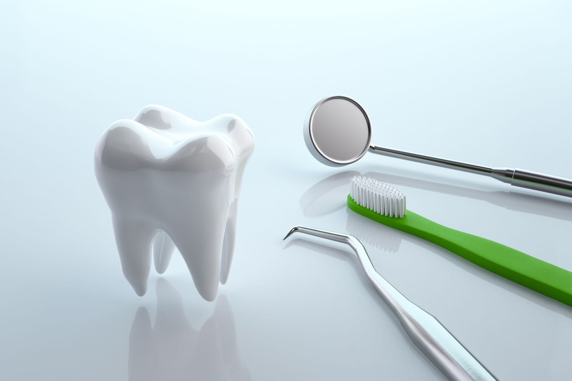 A tooth and dental instruments on a white surface