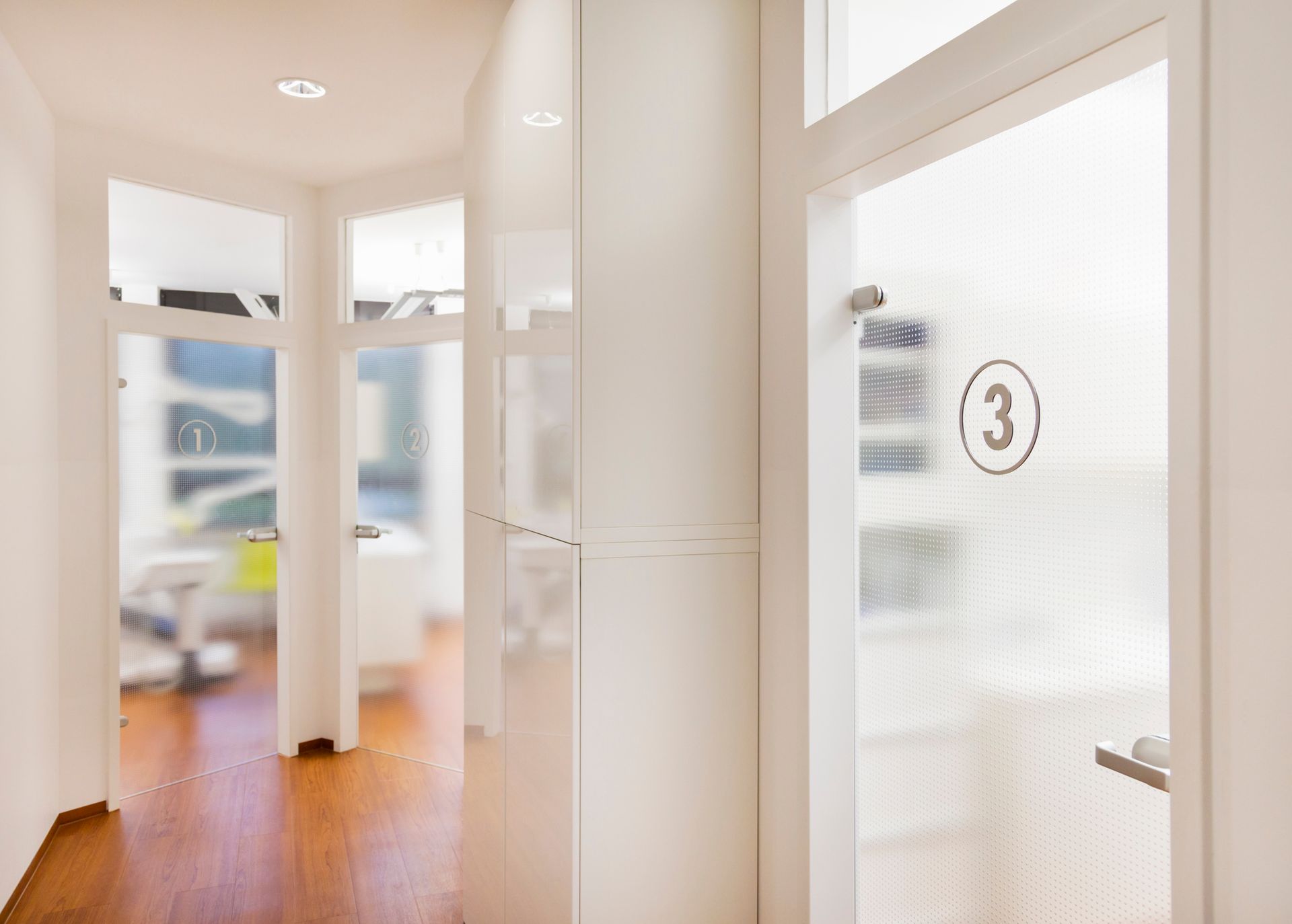 A hallway with a glass door and the number 3 on it