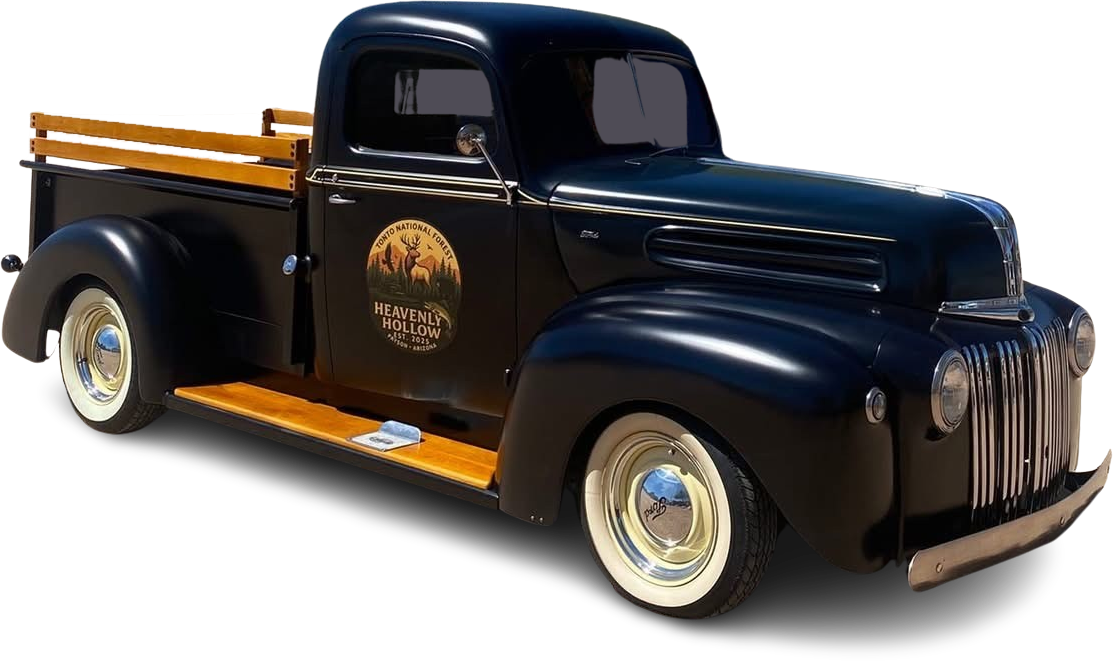 Glossy black vintage pickup truck with gold trim and whitewall tires, side view on white background