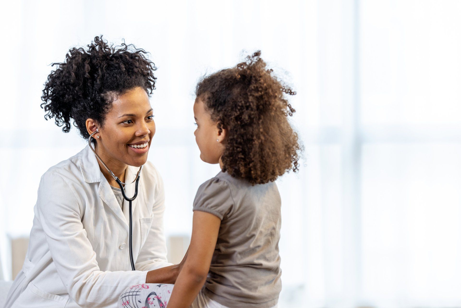 Female Doctor Checks Girl's Heartbeat — Surprise, AZ — Arizona Kids Pediatrics