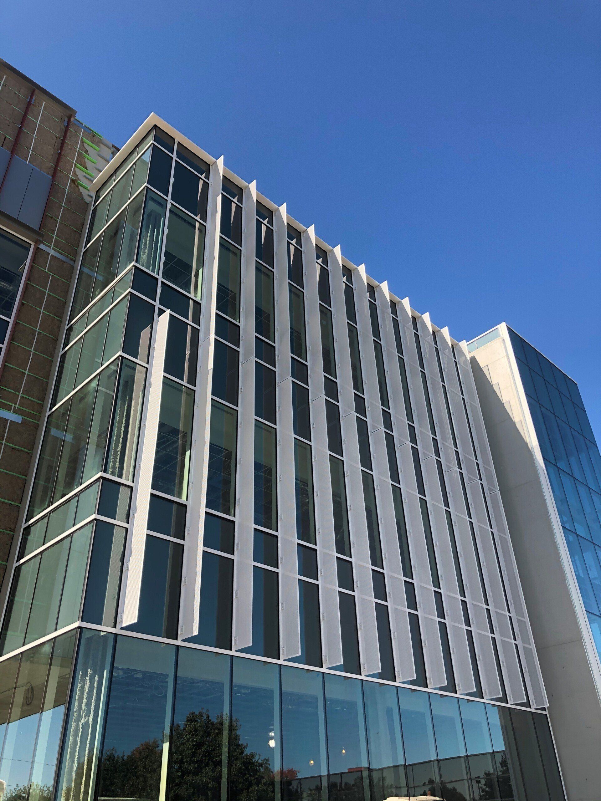 A building with a lot of windows and a blue sky in the background