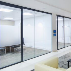 A room with a lot of glass doors and a couch