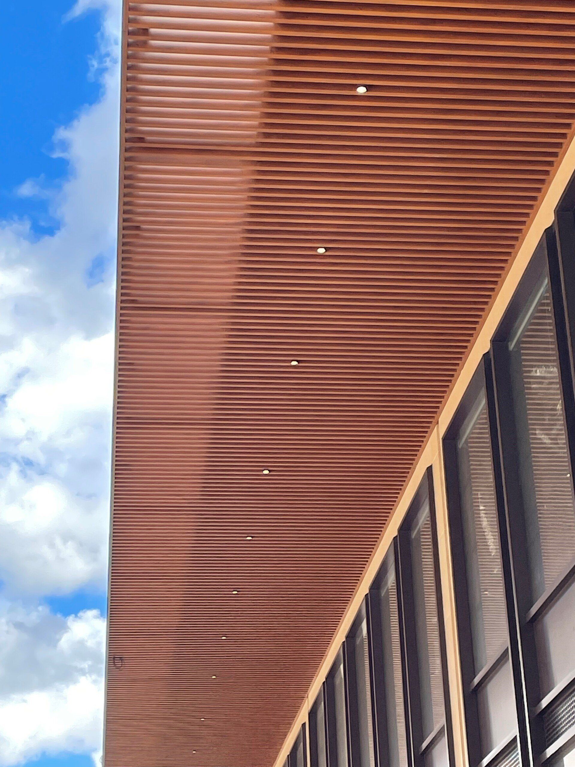 Looking up at the ceiling of a building with a blue sky in the background