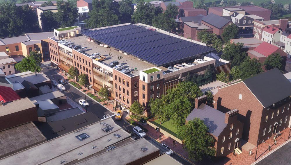 An aerial view of a building with solar panels on the roof