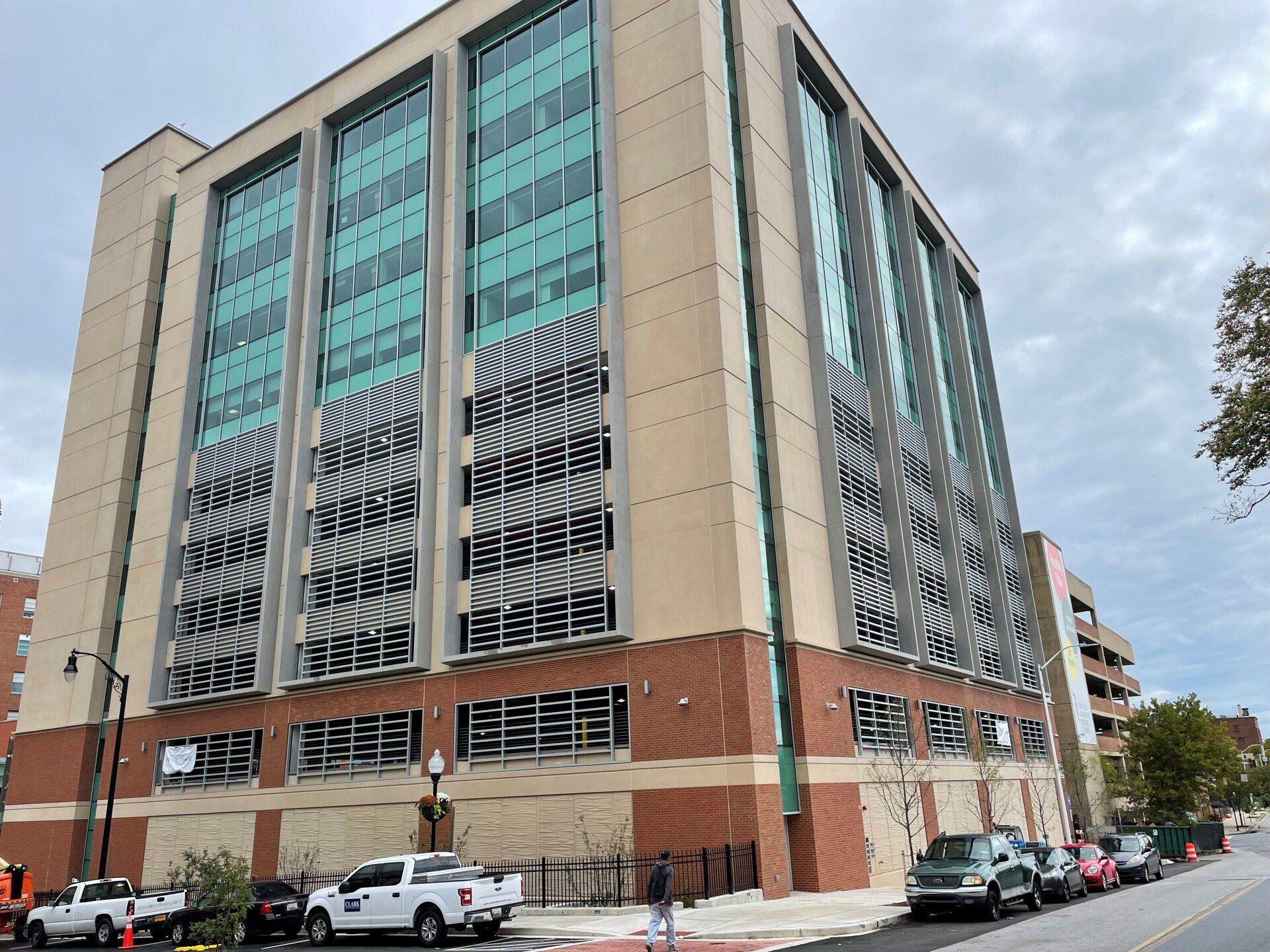A large building with a lot of windows and cars parked in front of it