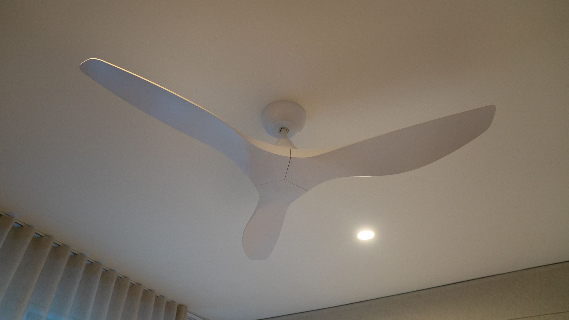White Ceiling Fan with Three Blades and A Light in A Room Ceiling Corner — Ralph Ottmann Electrical in Pomona, QLD