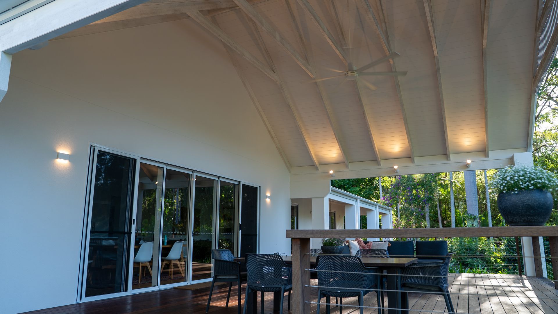 Covered Patio with White Ceiling, Glass Doors, Outdoor Table and Chairs, and A Garden View — Ralph Ottmann Electrical in Pomona, QLD