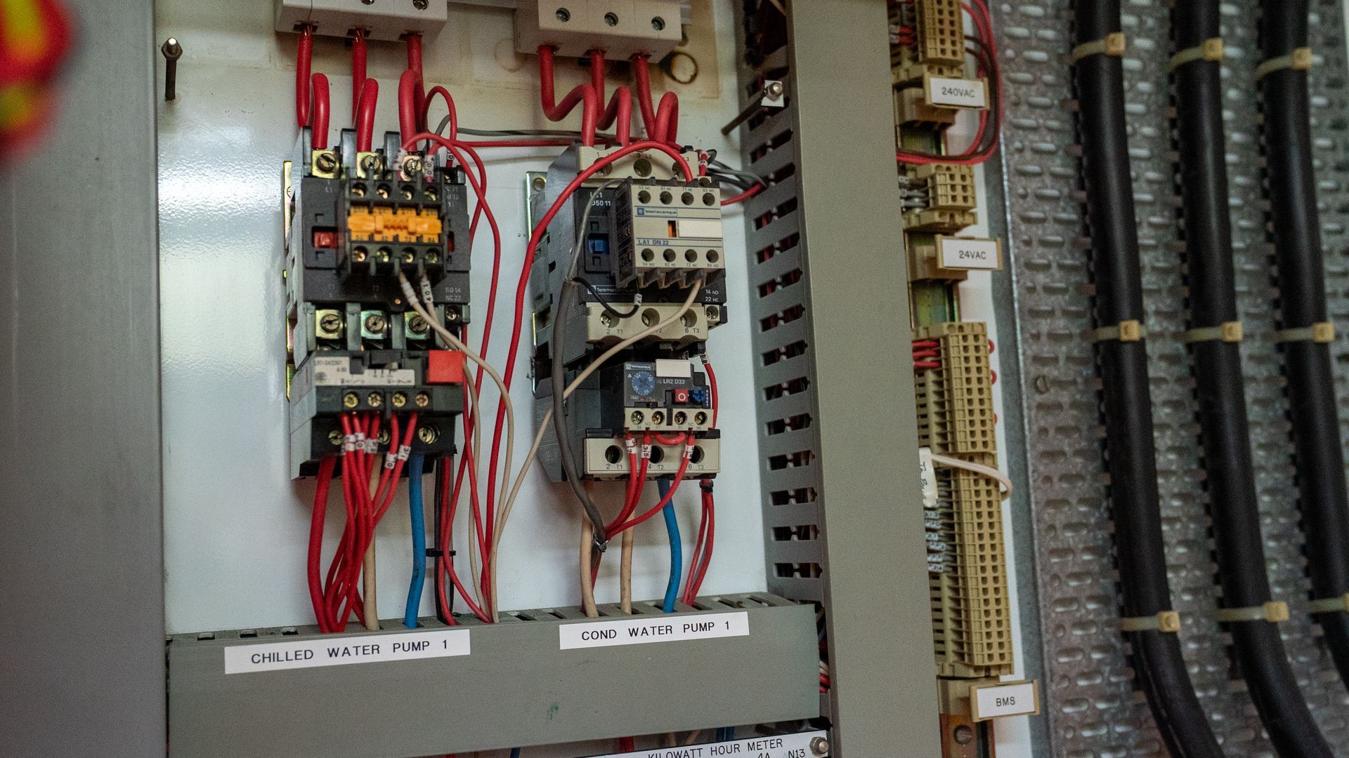 Open Electrical Control Panel with Red Wiring, Circuit Breakers, and Terminal Blocks Inside a Gray Cabinet — Ralph Ottmann Electrical in Pomona, QLD