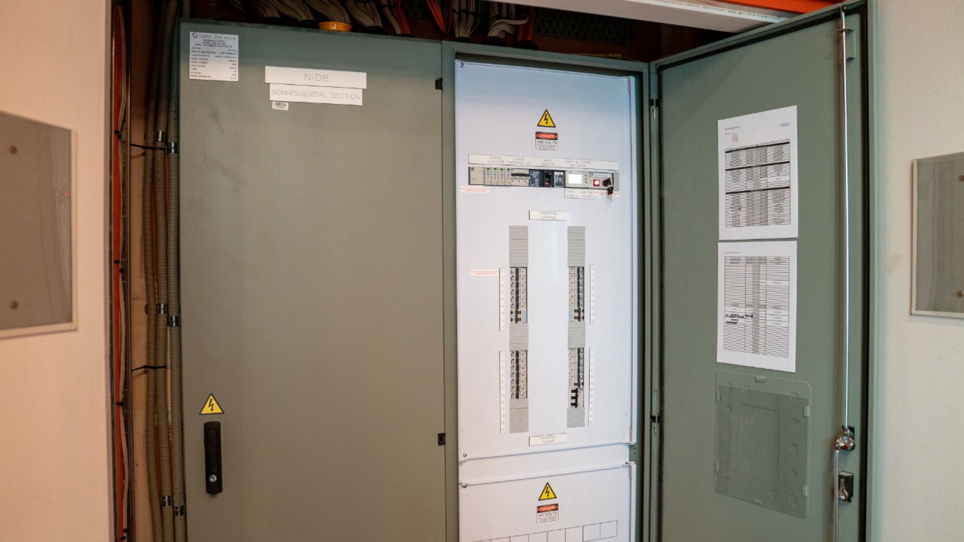 Open Electrical Switchgear Cabinet with Gray and White Panels in An Industrial Room — Ralph Ottmann Electrical in Pomona, QLD