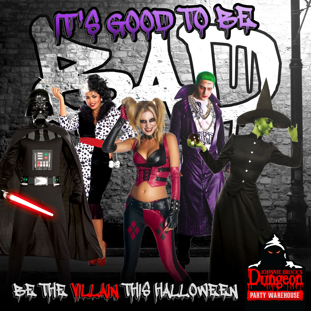A group of people dressed in halloween costumes are standing in front of a brick wall.