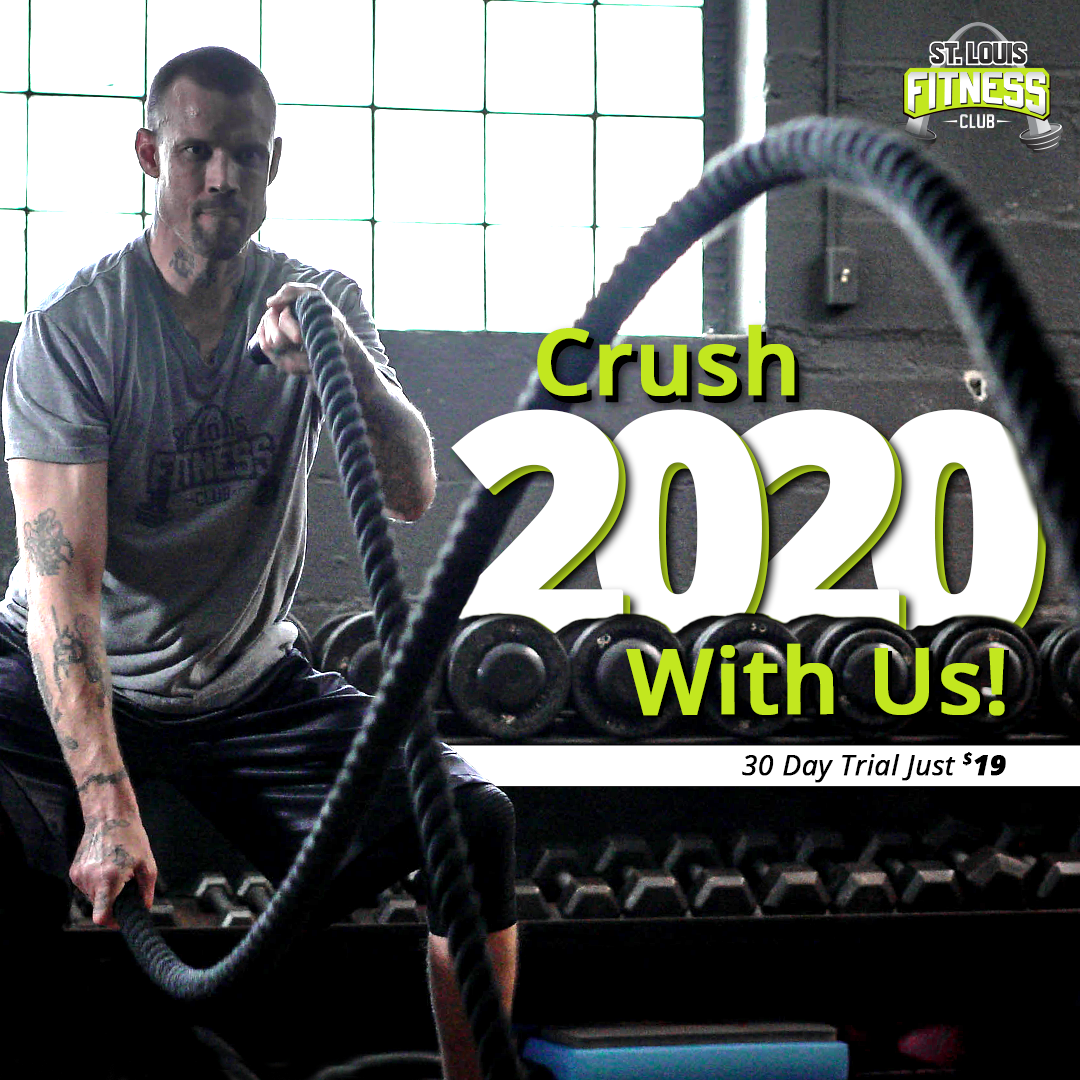 A man is holding a rope in front of a sign that says crush 2020 with us.