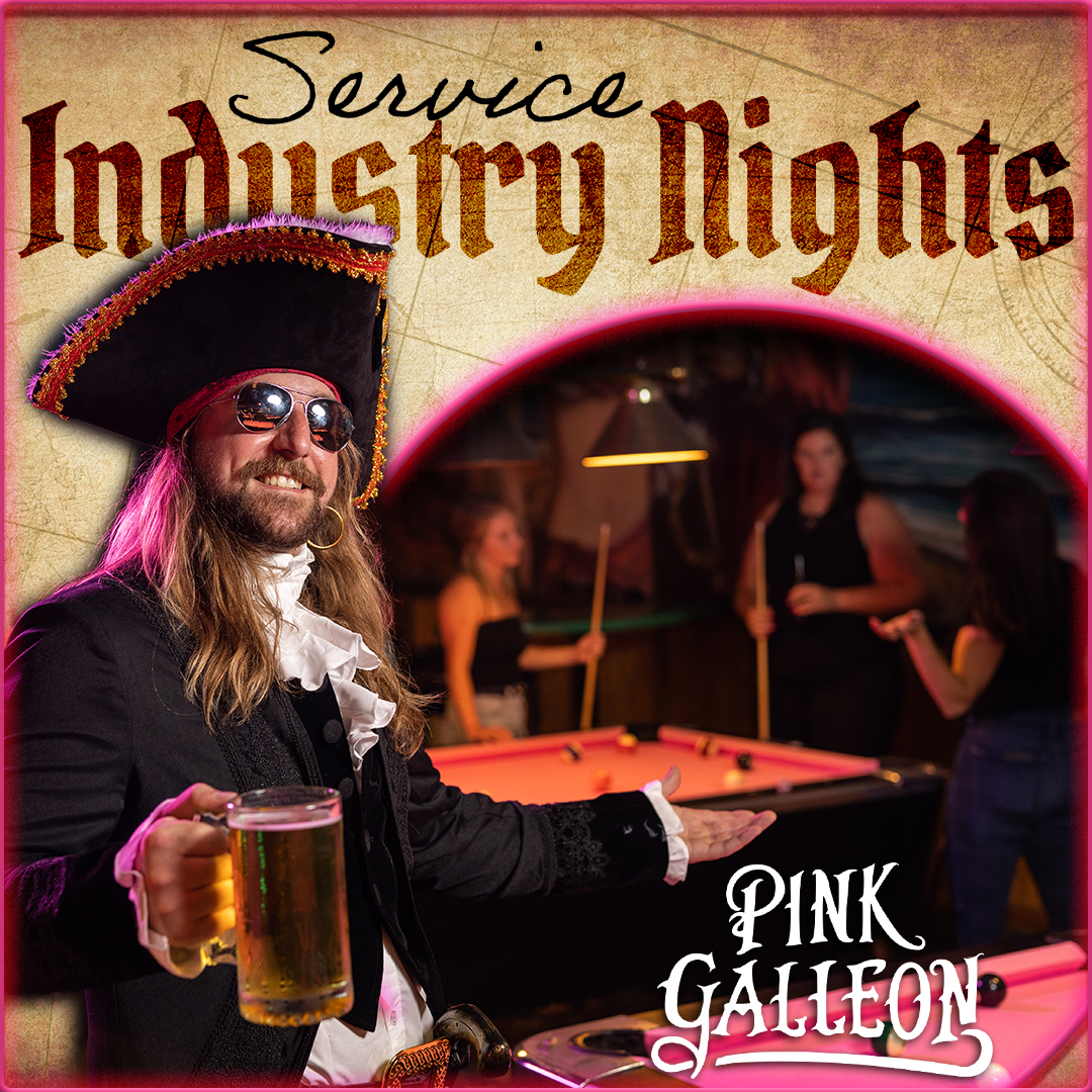 A man in a pirate costume is holding a beer in front of a pool table