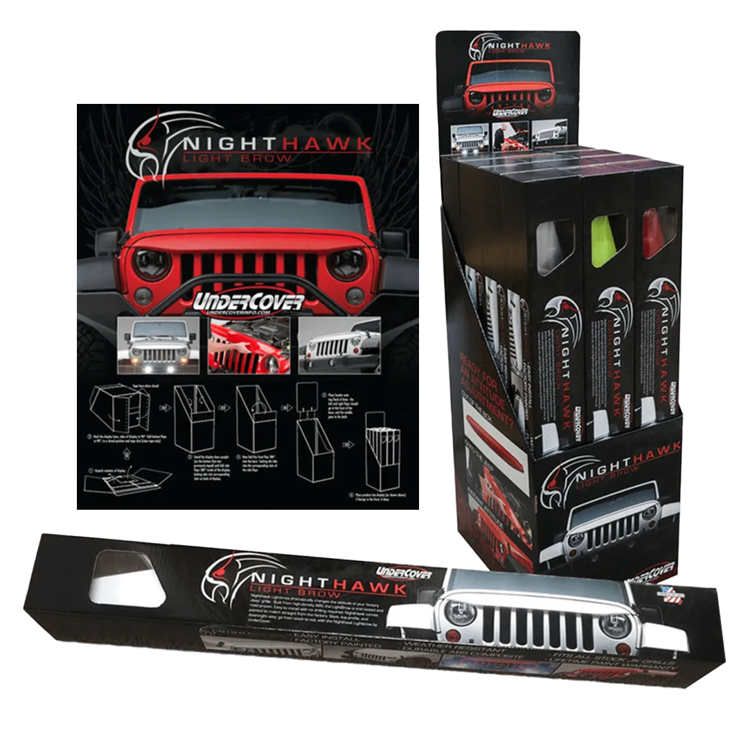 A red jeep is sitting next to a box of nighthawk undercover.