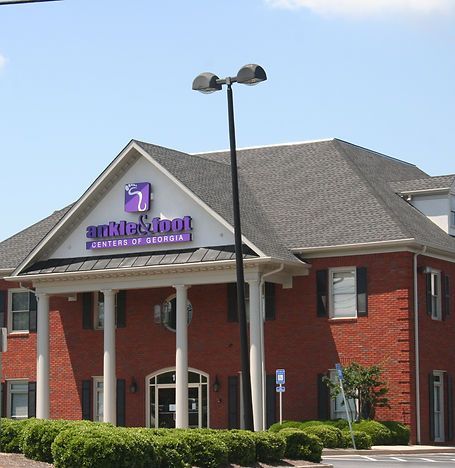 Exterior of the Cornerstone Credit Union of Georgia building with red brick and a gray roof.