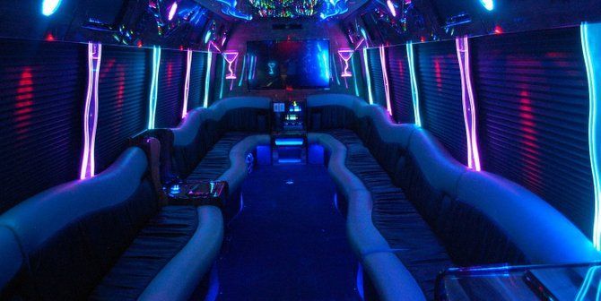RPD party bus interior with neon lighting and wraparound seating - bachelor party bus NJ