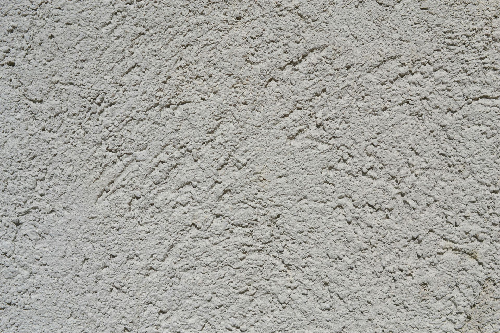 Close-up of rough light gray stucco wall texture