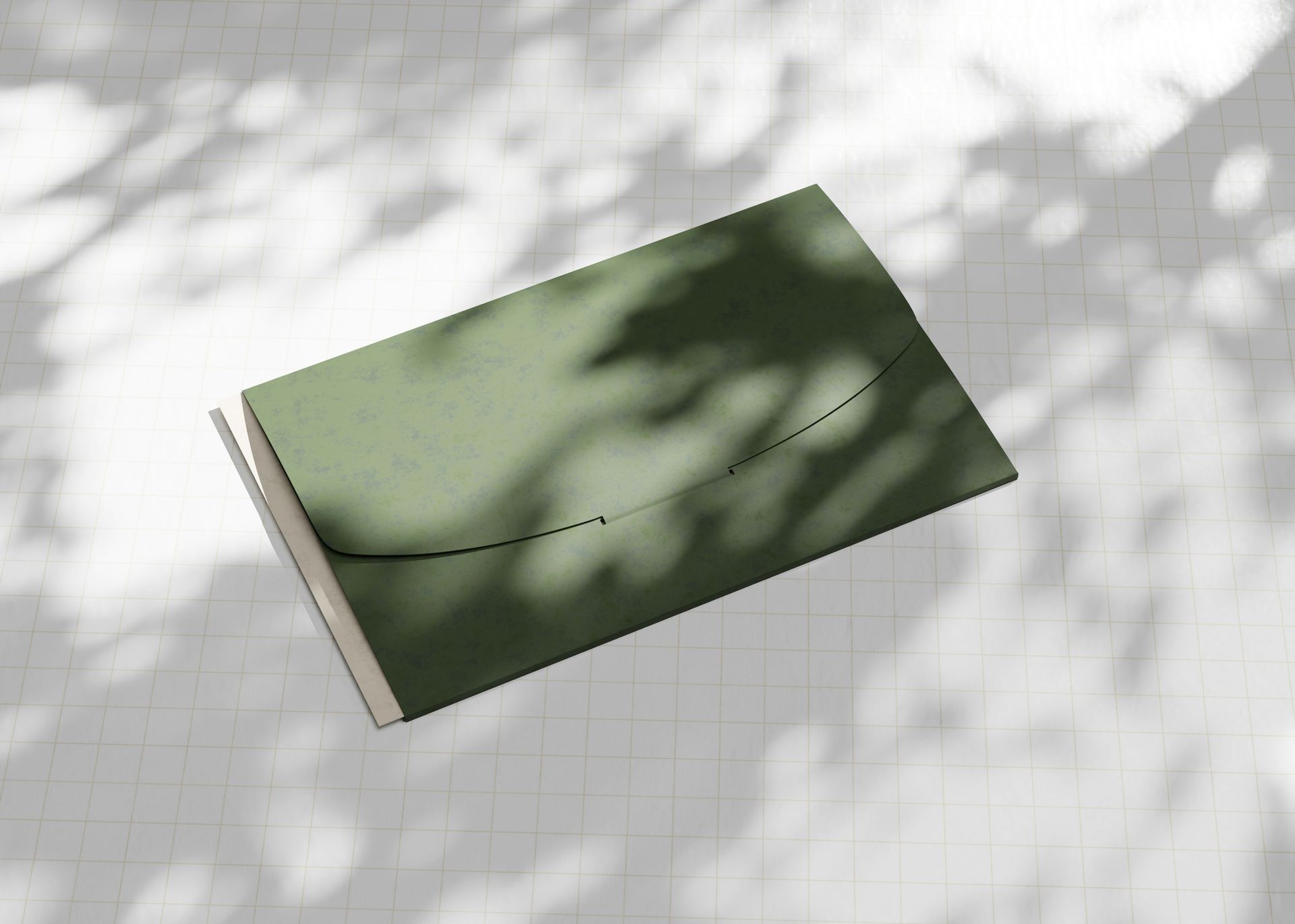A green envelope is sitting on a white brick floor.