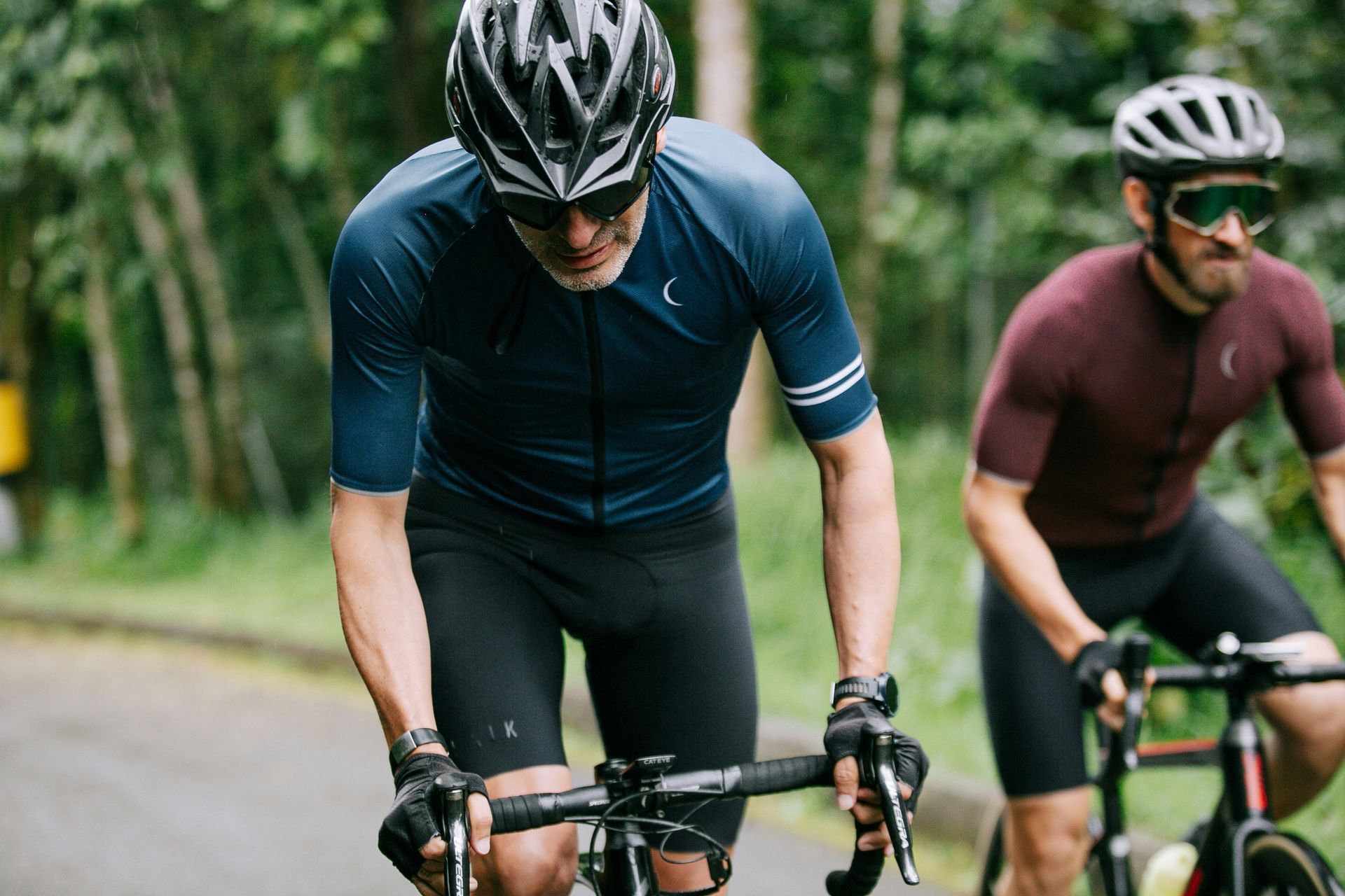 Two Cyclists Riding Bikes on a Road — EyeMax EyeCare in Singleton, NSW