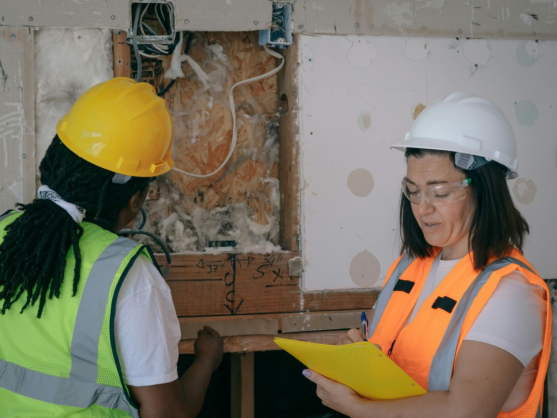 Two Construction Workers In Safety Vests And Helmets — EyeMax EyeCare in Wallsend, NSW