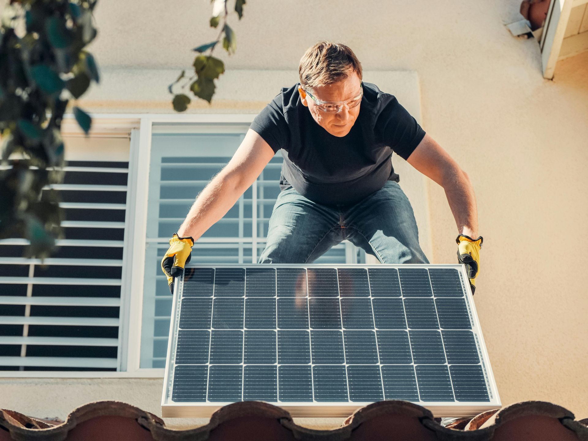 Man Installing a Solar Panel on a Roof — EyeMax EyeCare in Maitland, NSW
