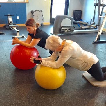 Two woman doing a ball exercise